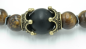 Preview: Tigeraugen Perlen Armband mit Lavasteinperle in zwei Kronen gefasst